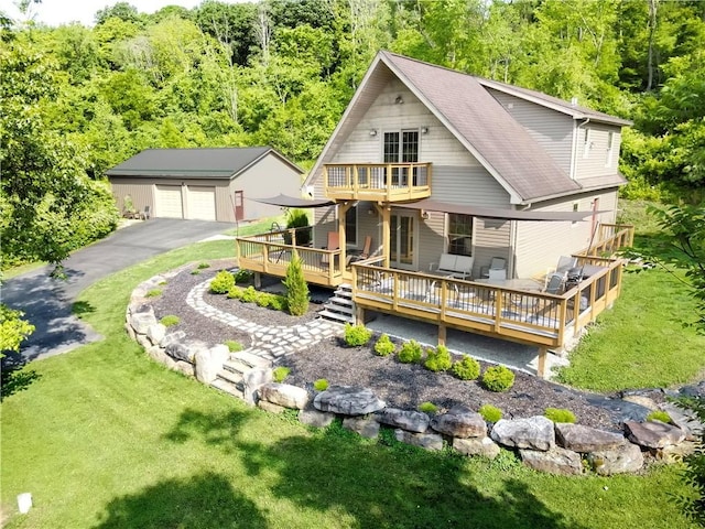 277 Dunn Rd, Hempfield Twp Wml, PA 15601 - back of property featuring an outbuilding, a deck, a garage, a balcony, and a view of trees