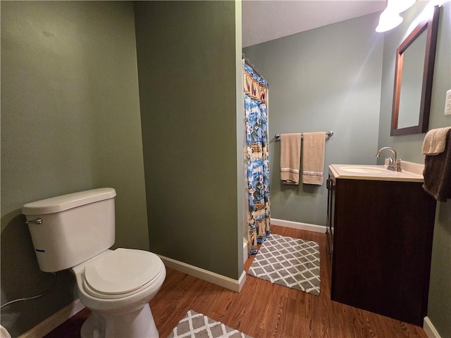 277 Dunn Rd, Hempfield Twp Wml, PA 15601 - full bath with toilet, wood finished floors, vanity, a shower with curtain, and baseboards