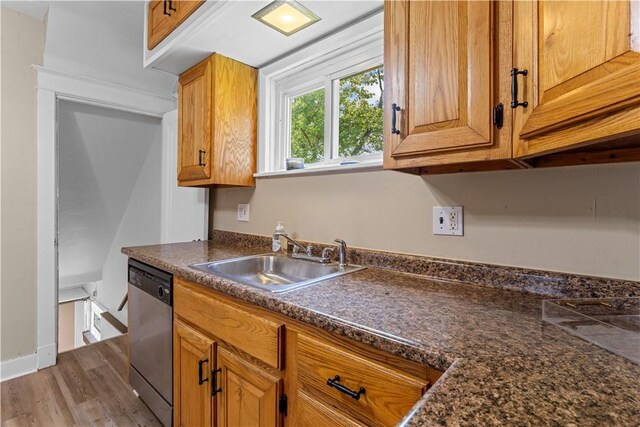 707 Hamil Rd, Penn Hills, PA 15147 - kitchen featuring dishwasher, dark countertops, wood finished floors, and brown cabinetry