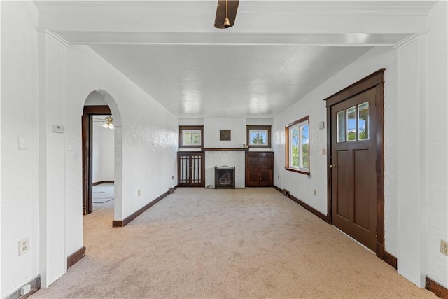707 Hamil Rd, Penn Hills, PA 15147 - unfurnished living room featuring light carpet, a brick fireplace, and ceiling fan