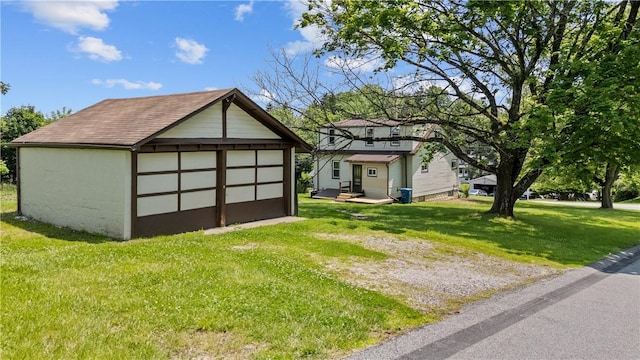 707 Hamil Rd, Penn Hills, PA 15147 - view of home's exterior with a detached garage, a yard, an outdoor structure, and a shingled roof