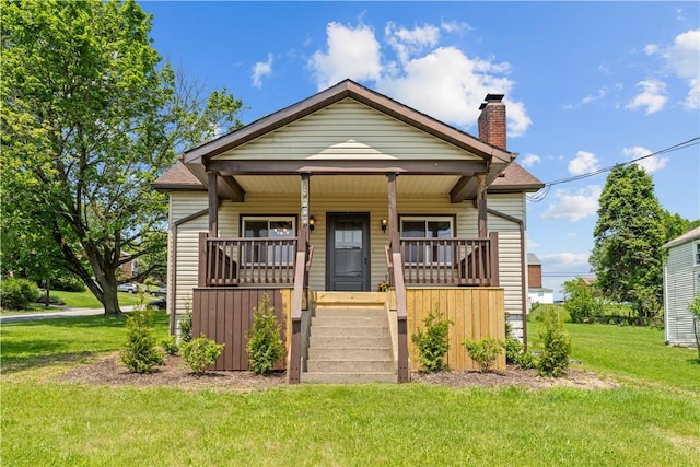 707 Hamil Rd, Penn Hills, PA 15147 - bungalow-style home with a porch, a front lawn, and a chimney