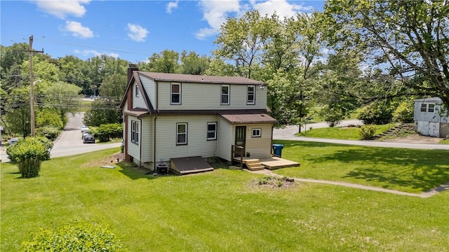707 Hamil Rd, Penn Hills, PA 15147 - rear view of house with a chimney, a yard, and view of scattered trees