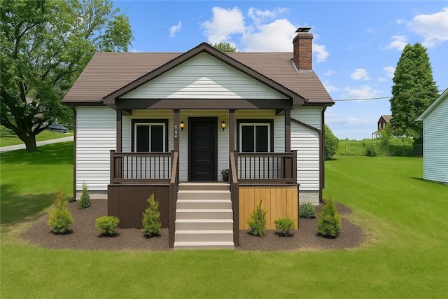 707 Hamil Rd, Penn Hills, PA 15147 - bungalow-style house with a porch, a front yard, stairs, and a chimney