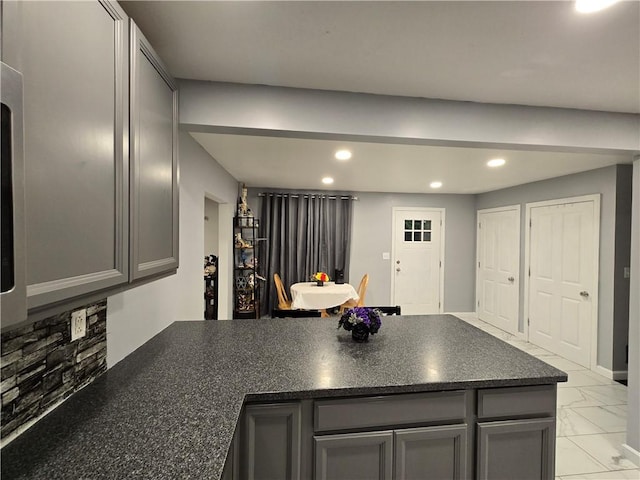 68 Kinsman Rd, West Salem Twp, PA 16125 - kitchen with gray cabinetry, a peninsula, recessed lighting, light marble finish floors, and dark stone counters
