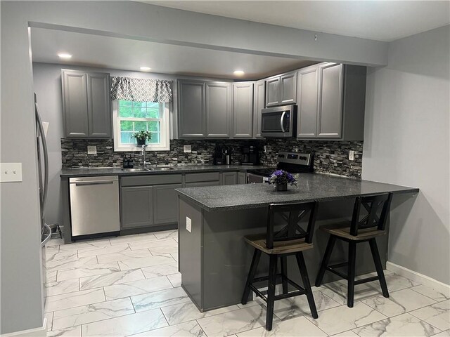 68 Kinsman Rd, West Salem Twp, PA 16125 - kitchen with appliances with stainless steel finishes, light marble finish floors, dark countertops, a peninsula, and recessed lighting