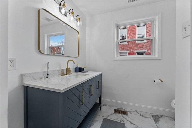 4410 Sherrod St, Lawrenceville, PA 15201 - bathroom with vanity, marble look tile flooring, baseboards, and toilet