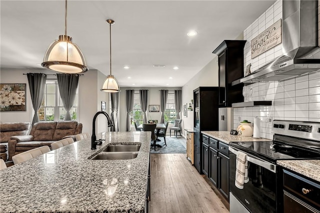 305 Tillary Ln Unit 202, Cranberry Twp, PA 16066 - kitchen with stainless steel electric range, a sink, wall chimney range hood, dark cabinets, and recessed lighting