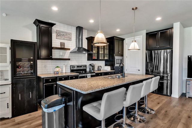 305 Tillary Ln Unit 202, Cranberry Twp, PA 16066 - kitchen featuring appliances with stainless steel finishes, a sink, wall chimney range hood, light stone countertops, and recessed lighting