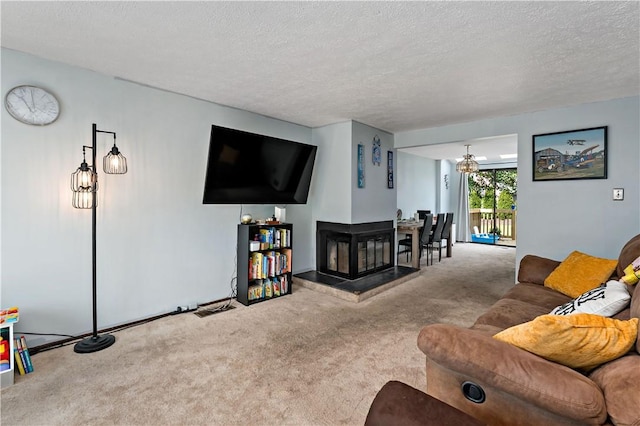 303 Serendipity Dr, Moon/Crescent Twp, PA 15108 - living room featuring carpet floors, a textured ceiling, and a wood stove