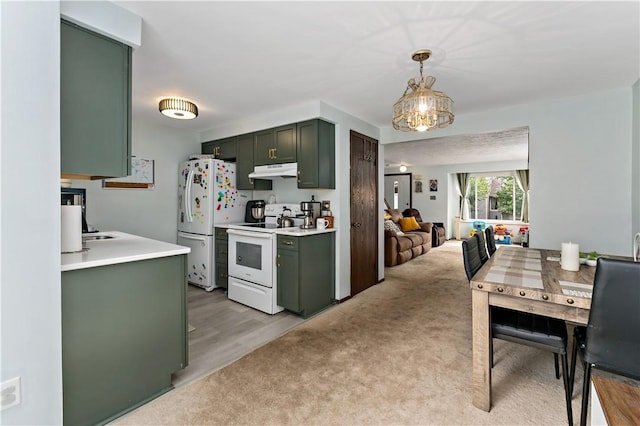 303 Serendipity Dr, Moon/Crescent Twp, PA 15108 - kitchen with green cabinetry, white appliances, under cabinet range hood, light countertops, and hanging light fixtures