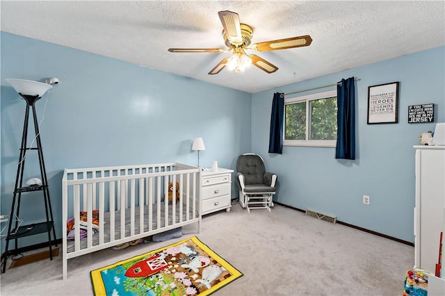 303 Serendipity Dr, Moon/Crescent Twp, PA 15108 - bedroom with carpet, a textured ceiling, a nursery area, a ceiling fan, and baseboards