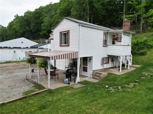 1467 Hayden Blvd, Elizabeth Twp/Boro, PA 15037 - back of property with a patio area, a lawn, an attached garage, and a forest view