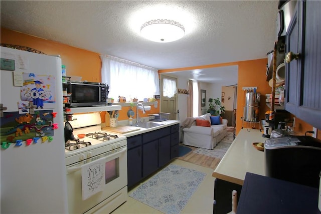 1467 Hayden Blvd, Elizabeth Twp/Boro, PA 15037 - kitchen with white appliances, a sink, a textured ceiling, light countertops, and open floor plan