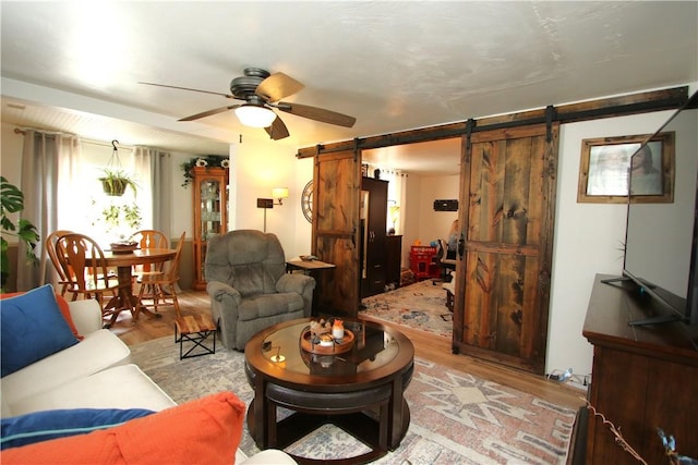 1467 Hayden Blvd, Elizabeth Twp/Boro, PA 15037 - living area featuring a barn door, light wood-type flooring, and ceiling fan