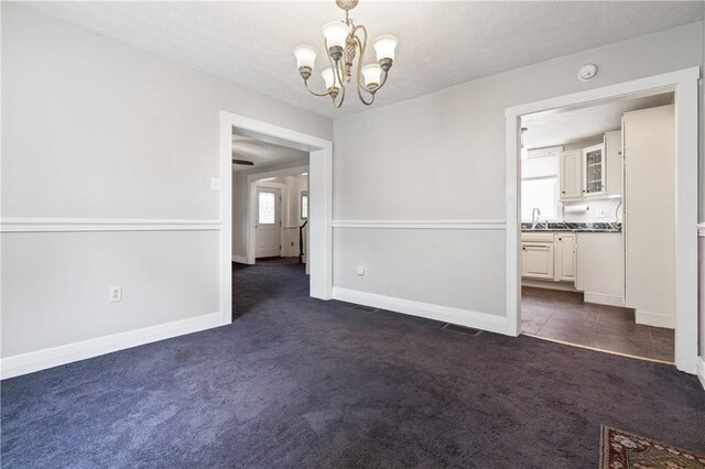 338 Buffalo St, Beaver, PA 15009 - spare room with dark colored carpet, a chandelier, baseboards, and a smoke detector