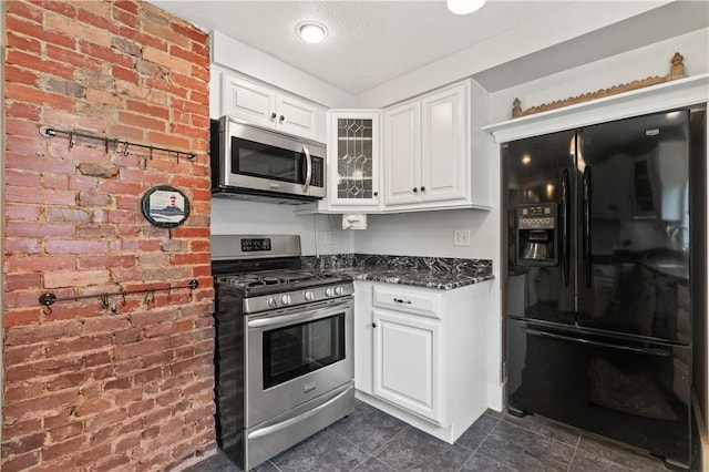 338 Buffalo St, Beaver, PA 15009 - kitchen with appliances with stainless steel finishes, dark tile patterned floors, white cabinets, glass insert cabinets, and dark stone countertops