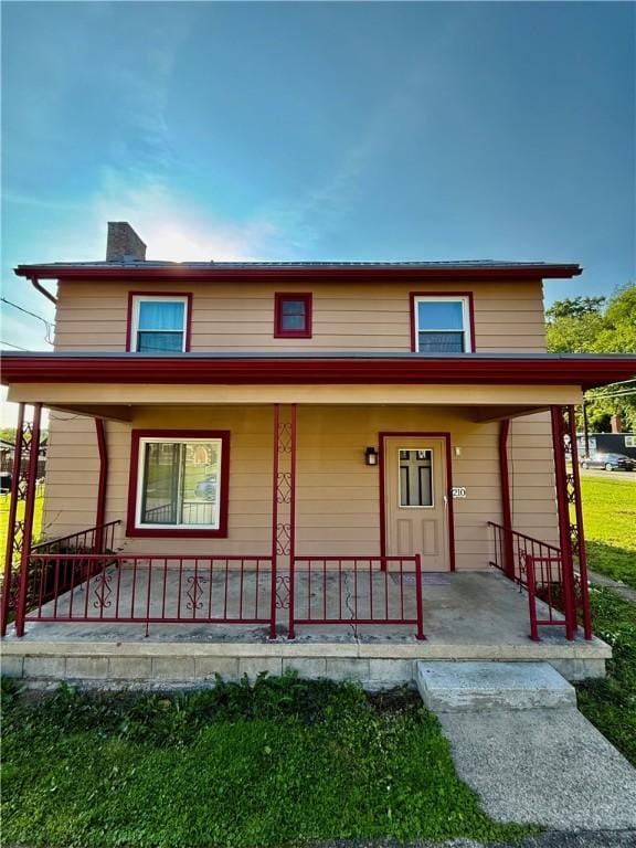 210 Griscom St, Dawson, PA 15428 - view of front of home with a porch and a chimney