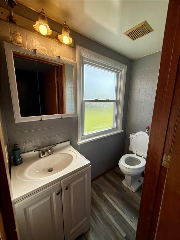 210 Griscom St, Dawson, PA 15428 - bathroom with toilet, vanity, and wood finished floors