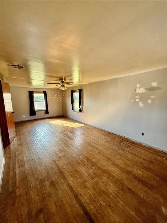 210 Griscom St, Dawson, PA 15428 - unfurnished living room featuring wood finished floors, a ceiling fan, and baseboards