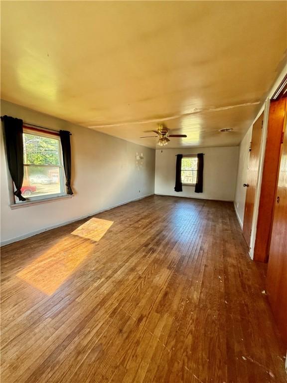 210 Griscom St, Dawson, PA 15428 - spare room featuring wood finished floors, a ceiling fan, and baseboards
