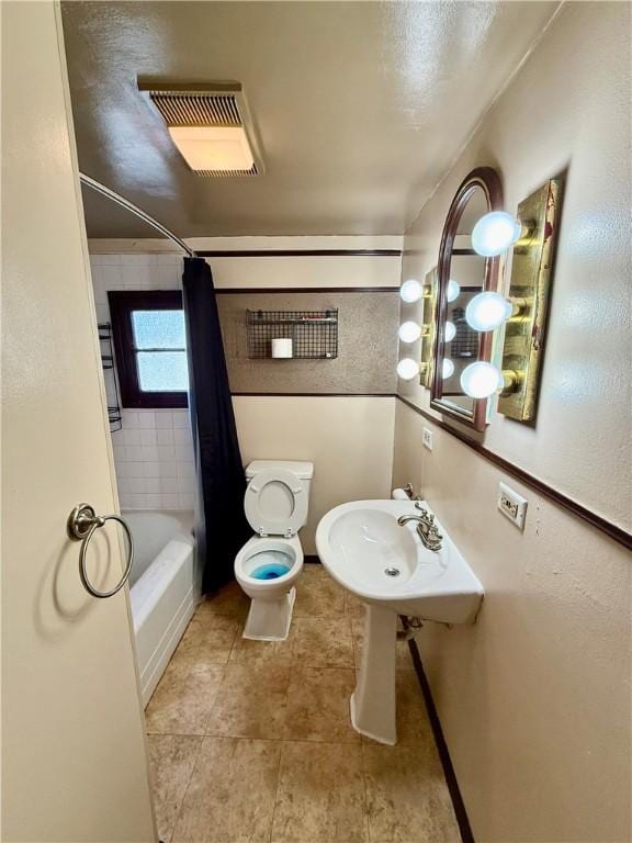 210 Griscom St, Dawson, PA 15428 - full bath featuring shower / bath combo, toilet, and tile patterned floors