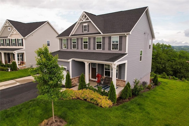 137 Red Horse Dr, Buffalo Twp But, PA 16055 - craftsman inspired home with covered porch, roof with shingles, a front yard, central AC unit, and board and batten siding
