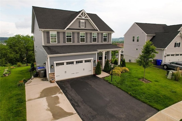137 Red Horse Dr, Buffalo Twp But, PA 16055 - craftsman-style house featuring asphalt driveway, board and batten siding, a garage, stone siding, and a front yard