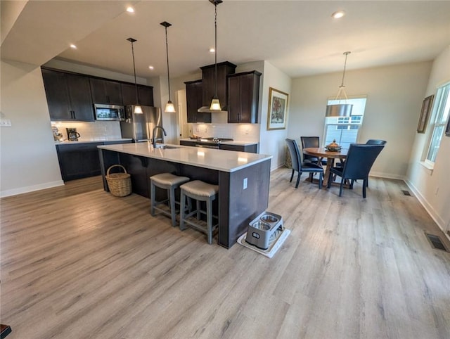 137 Red Horse Dr, Buffalo Twp But, PA 16055 - kitchen with stainless steel microwave, light wood finished floors, light countertops, tasteful backsplash, and recessed lighting