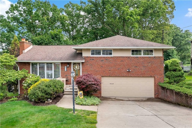 315 Yarrow Ln, Pleasant Hills, PA 15236 - tri-level home with a chimney, brick siding, a garage, concrete driveway, and roof with shingles