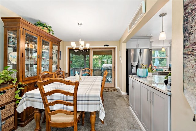 315 Yarrow Ln, Pleasant Hills, PA 15236 - dining area with a chandelier, healthy amount of natural light, light colored carpet, and baseboards