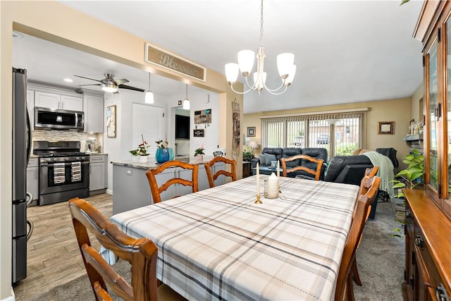 315 Yarrow Ln, Pleasant Hills, PA 15236 - dining space with a chandelier, light wood finished floors, and a ceiling fan