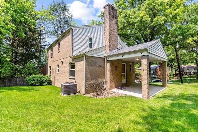 455 Darrell Dr, Penn Hills, PA 15235 - back of property featuring central AC unit, a chimney, a patio area, and brick siding
