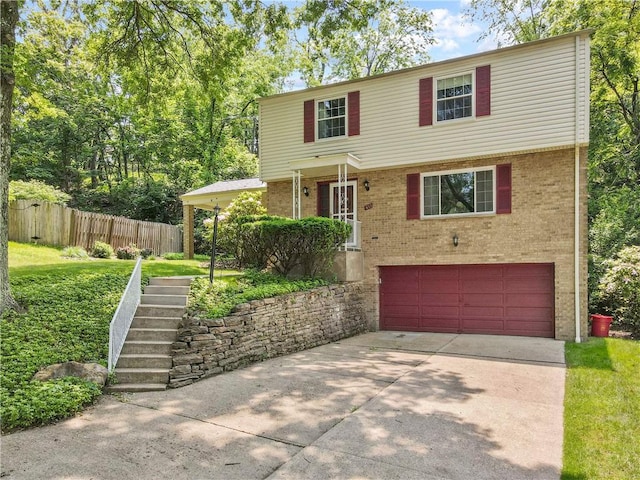 455 Darrell Dr, Penn Hills, PA 15235 - view of front facade with an attached garage, driveway, brick siding, and stairway