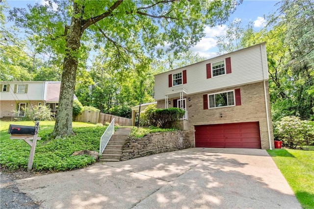 455 Darrell Dr, Penn Hills, PA 15235 - view of front of property with an attached garage, concrete driveway, brick siding, and stairway