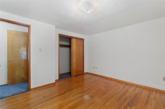 455 Darrell Dr, Penn Hills, PA 15235 - unfurnished bedroom featuring baseboards, light wood-style flooring, and a closet