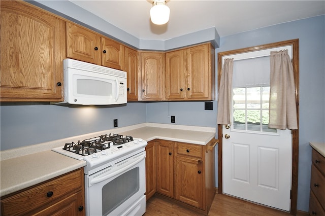 3743 Grant St, Castle Shannon, PA 15234 - kitchen featuring white appliances, light countertops, light wood-style floors, and brown cabinets