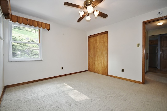 3743 Grant St, Castle Shannon, PA 15234 - unfurnished bedroom featuring a closet, light colored carpet, baseboards, ceiling fan, and freestanding refrigerator