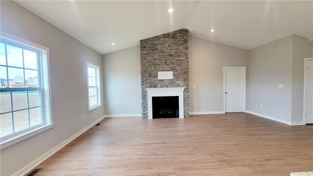 168 Twin Oaks Dr, Buffalo Twp, PA 16055 - unfurnished living room featuring light wood-style flooring, a stone fireplace, and high vaulted ceiling