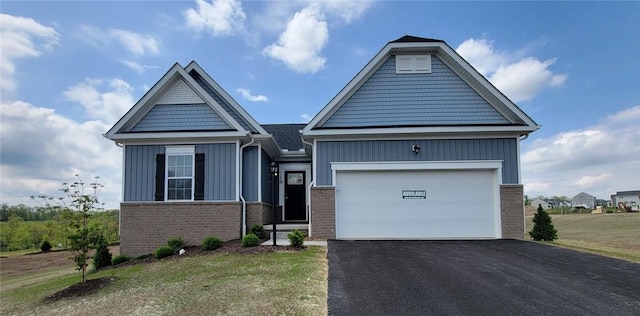 168 Twin Oaks Dr, Buffalo Twp, PA 16055 - view of front facade with board and batten siding, brick siding, driveway, and a garage