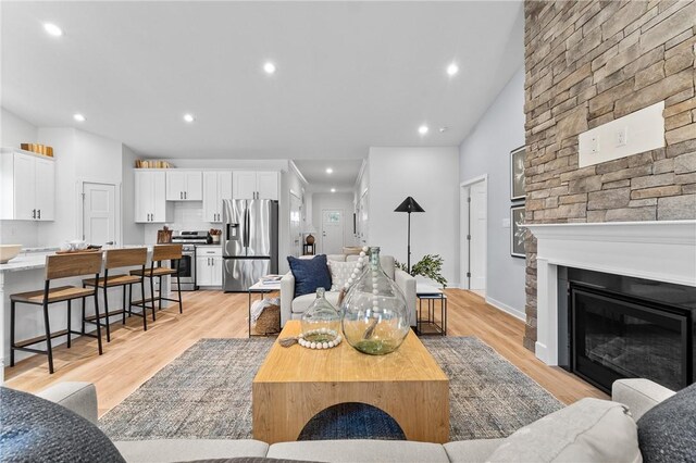 168 Twin Oaks Dr, Buffalo Twp, PA 16055 - living room featuring a glass covered fireplace, light wood finished floors, and recessed lighting