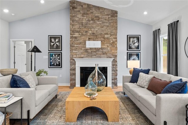168 Twin Oaks Dr, Buffalo Twp, PA 16055 - living area with lofted ceiling, a stone fireplace, wood finished floors, and recessed lighting