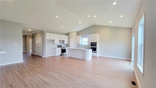 168 Twin Oaks Dr, Buffalo Twp, PA 16055 - kitchen with stainless steel range, open floor plan, under cabinet range hood, white cabinets, and recessed lighting