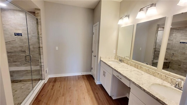 168 Twin Oaks Dr, Buffalo Twp, PA 16055 - bathroom featuring double vanity, wood finished floors, and a shower stall