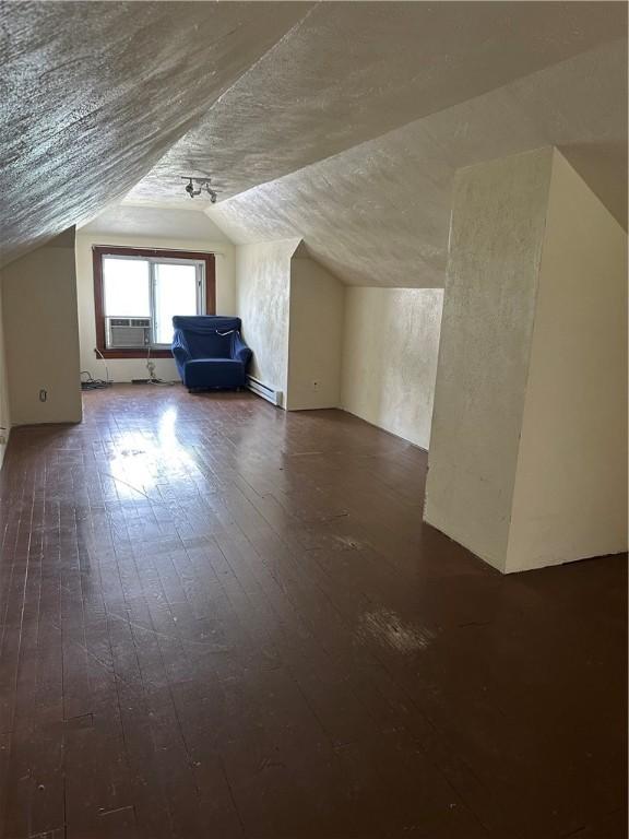 1810 Ridge Ave, Arnold, PA 15068 - bonus room with vaulted ceiling, dark wood-style flooring, a baseboard heating unit, and cooling unit