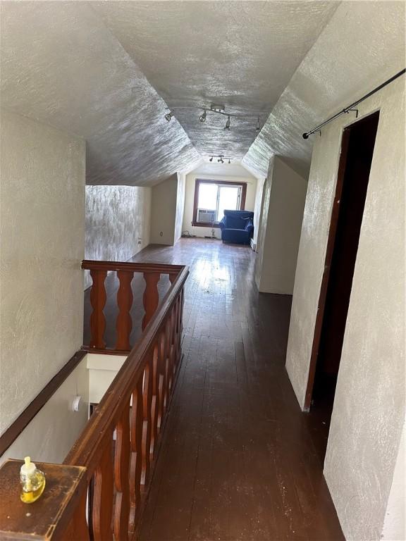 1810 Ridge Ave, Arnold, PA 15068 - hallway with hardwood / wood-style floors, lofted ceiling, a textured wall, a textured ceiling, and an upstairs landing
