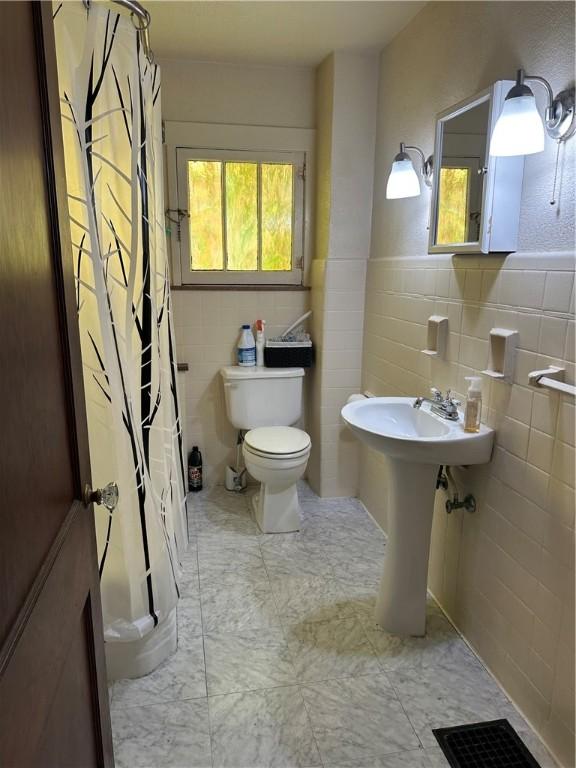 1810 Ridge Ave, Arnold, PA 15068 - bathroom with tile walls and a shower with shower curtain