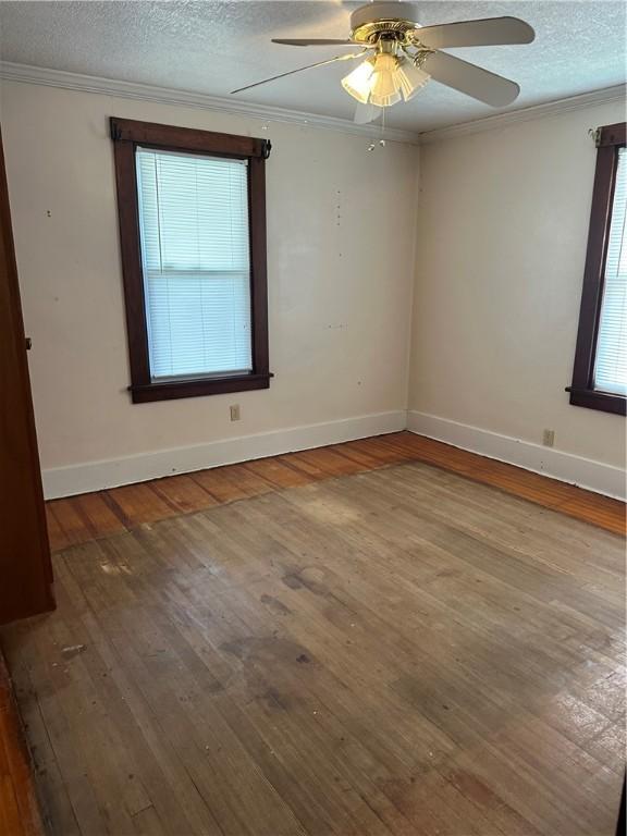 1810 Ridge Ave, Arnold, PA 15068 - unfurnished room with ornamental molding, wood-type flooring, a textured ceiling, and ceiling fan