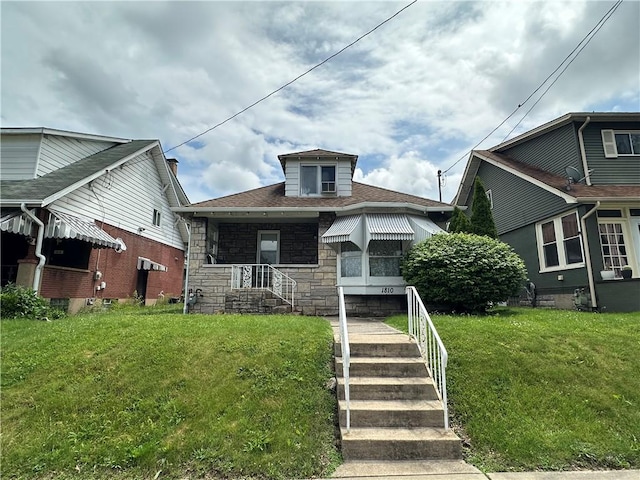 1810 Ridge Ave, Arnold, PA 15068 - bungalow-style house with stone siding, a front lawn, and a shingled roof