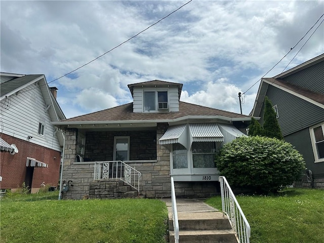 1810 Ridge Ave, Arnold, PA 15068 - bungalow featuring stone siding, a front yard, and roof with shingles